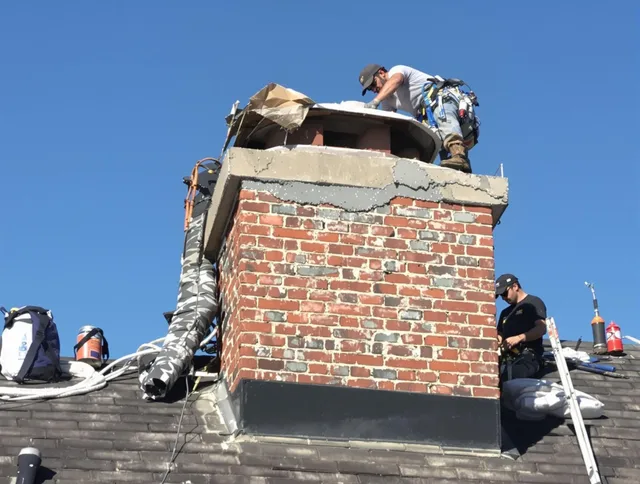 Port Chester Chimney Sweep installing a custom chimney crown in Port Chester, NY