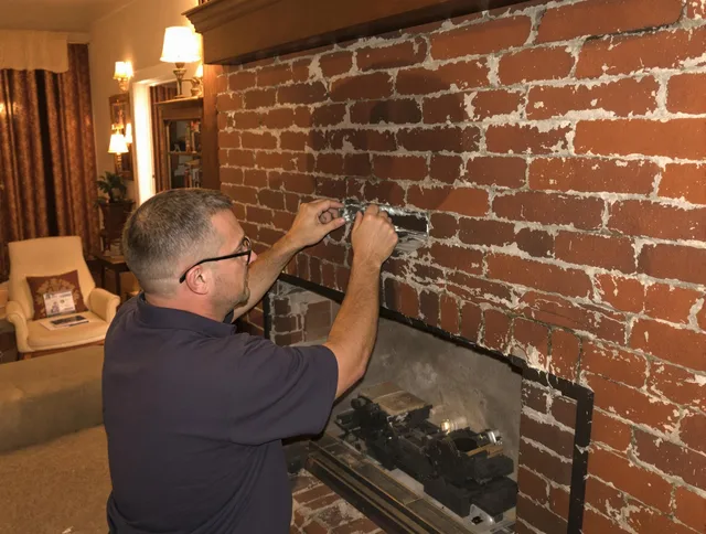 Port Chester Chimney Sweep expert fixing a fireplace in Port Chester, NY